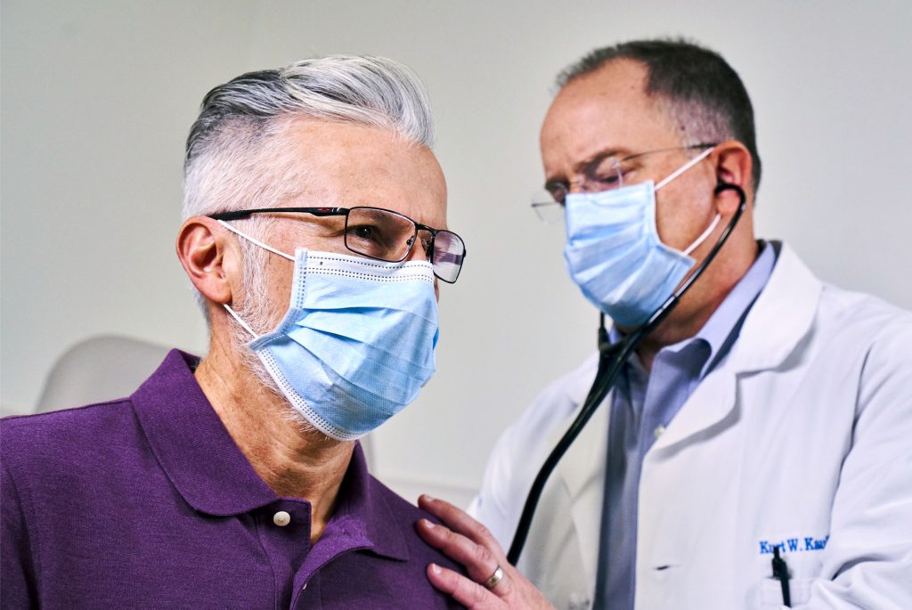 Physician working with a patient.